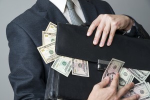 Businessman with briefcase full of money