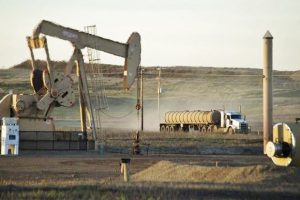 A service truck drives past an oil well on the Fort Berthold Indian Reservation in North Dakota