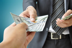 Hands giving & receiving money - United States Dollars (USD)