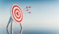 Dartboard with multiple arrows hitting the bullseye