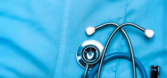 Image of a stethoscope in the pocket of a scrub top.