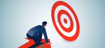 Photo of a person on an arrow that is moving toward a target.