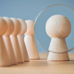 magnifying glass on pawns