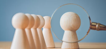 magnifying glass on pawns